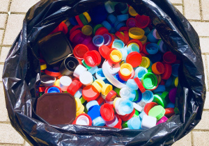 Nakrętki plastikowe w worku plastikowym.